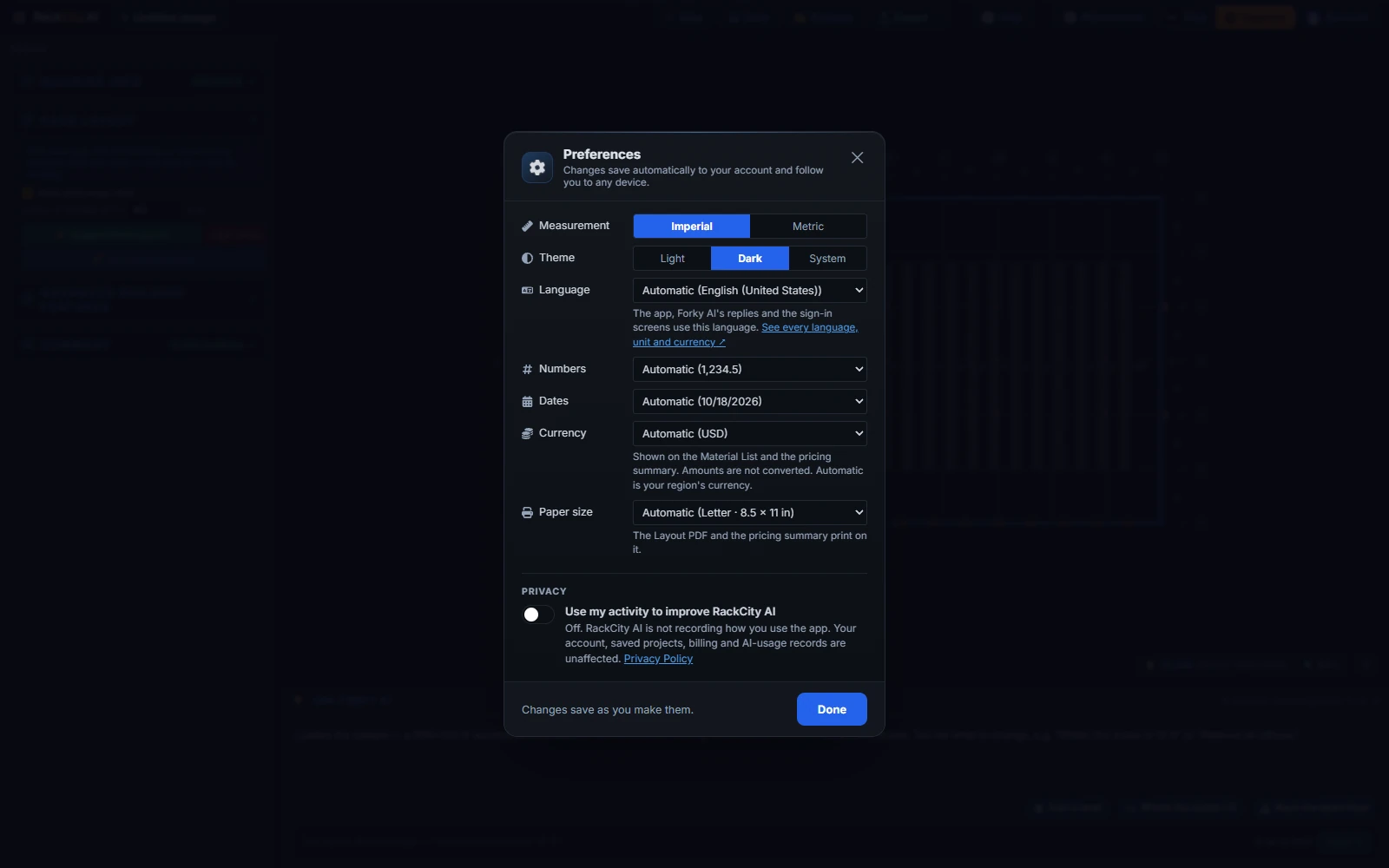 The RackCity AI Preferences window over a dimmed workspace: Measurement with Imperial selected and Metric beside it, Theme with Dark selected, Language on Automatic (English, United States) with a link to see every language, unit and currency, Numbers on Automatic (1,234.5), Dates on Automatic (10/18/2026), Currency on Automatic (USD), Paper size on Automatic (Letter, 8.5 by 11 in), a Privacy switch for usage recording, the line Changes save as you make them and a Done button
